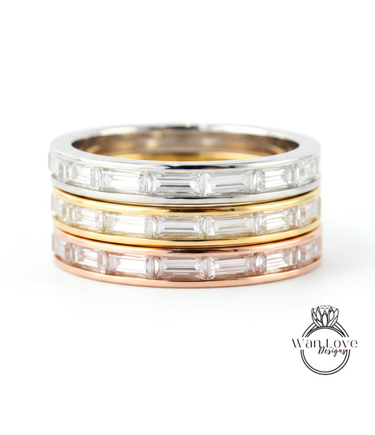 A stack of three rings with clear gemstones set in a silver band.