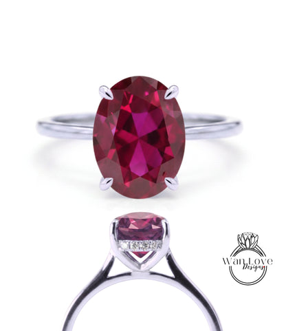 a beautiful engagement ring with a large oval-shaped red gemstone set in a silver band.