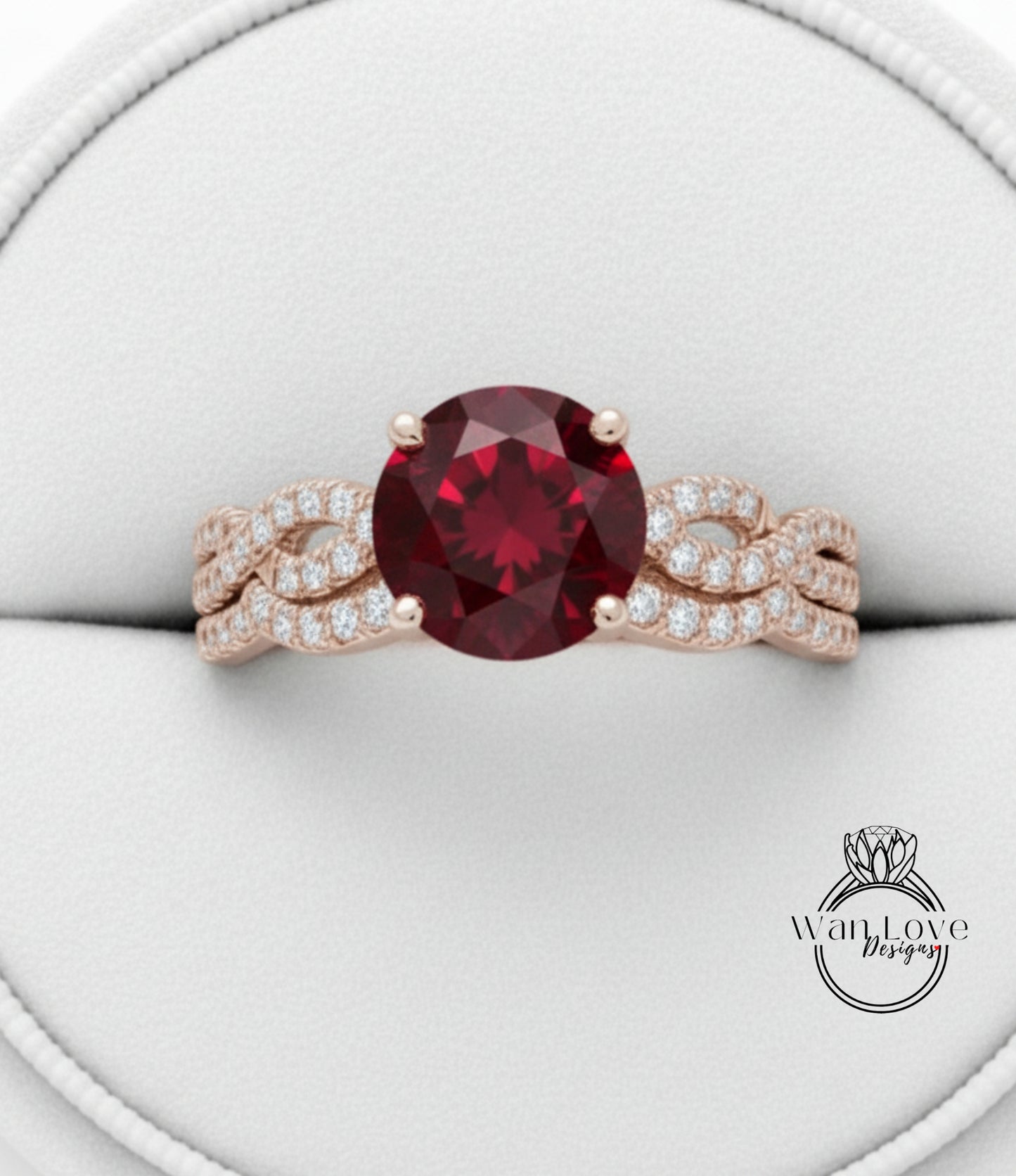A close-up image of a gold ring with a large, deep red gemstone at the center, surrounded by smaller diamonds.