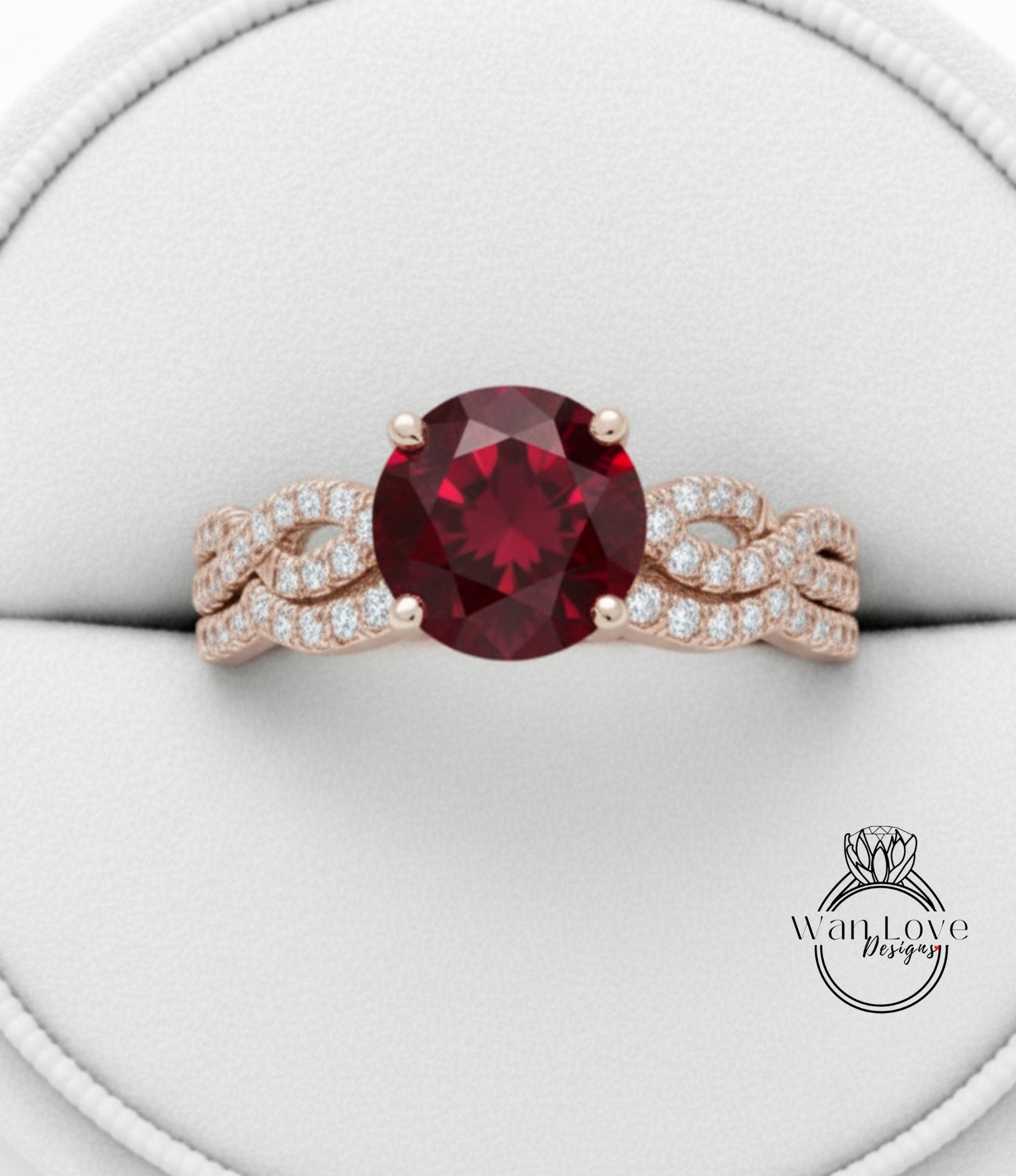 A close-up image of a gold ring with a large, deep red gemstone at the center, surrounded by smaller diamonds.
