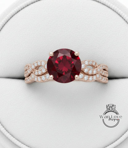 A close-up image of a gold ring with a large, deep red gemstone at the center, surrounded by smaller diamonds.
