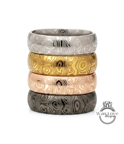 A stack of four rings with unique, colorful designs.