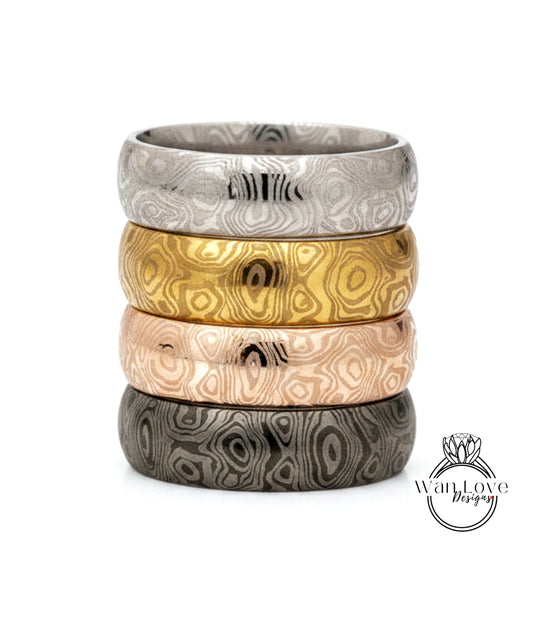 A stack of four rings with unique, colorful designs.