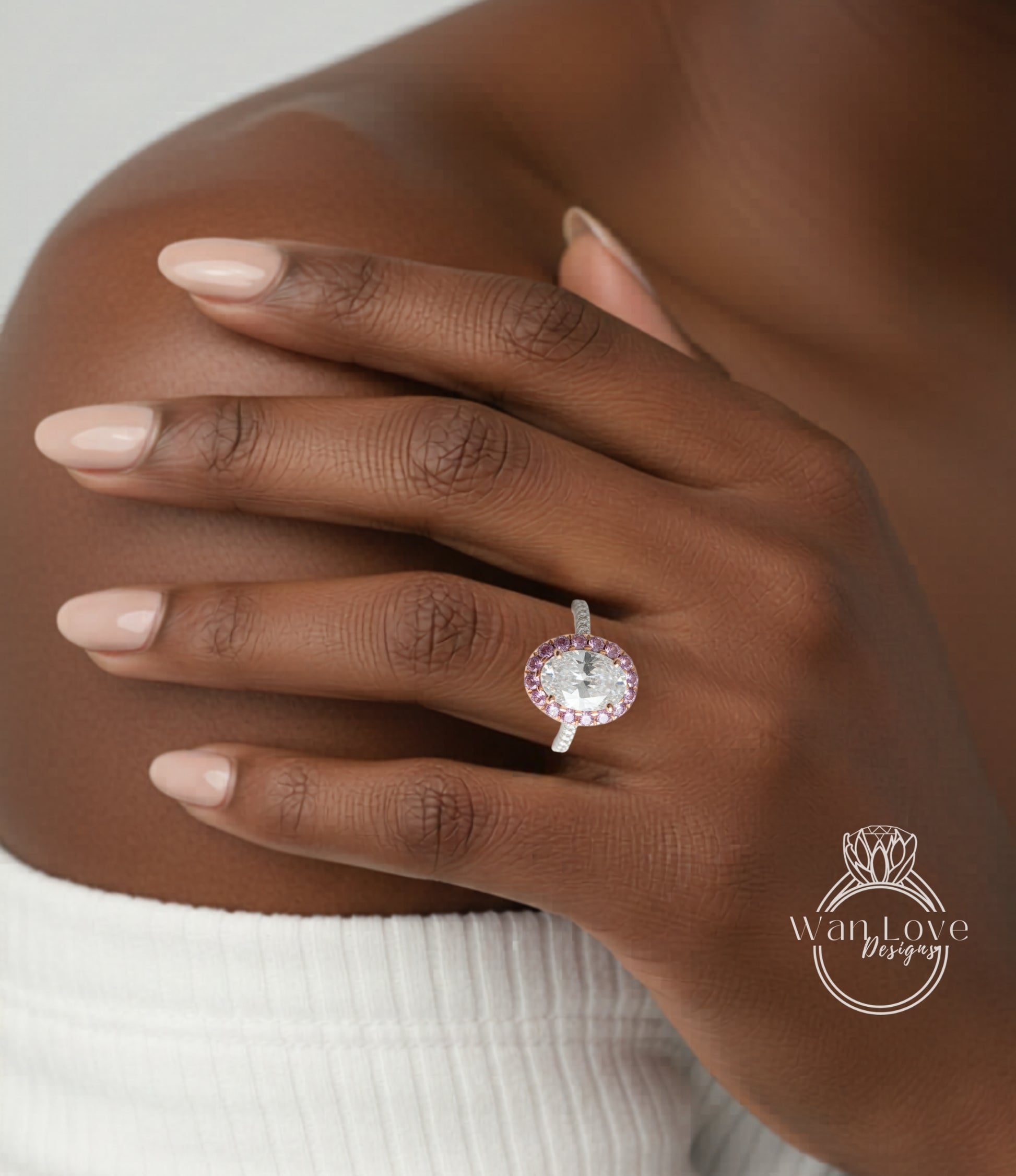 A close-up of a person's hand wearing a ring with a large, round gemstone set in a ring band.