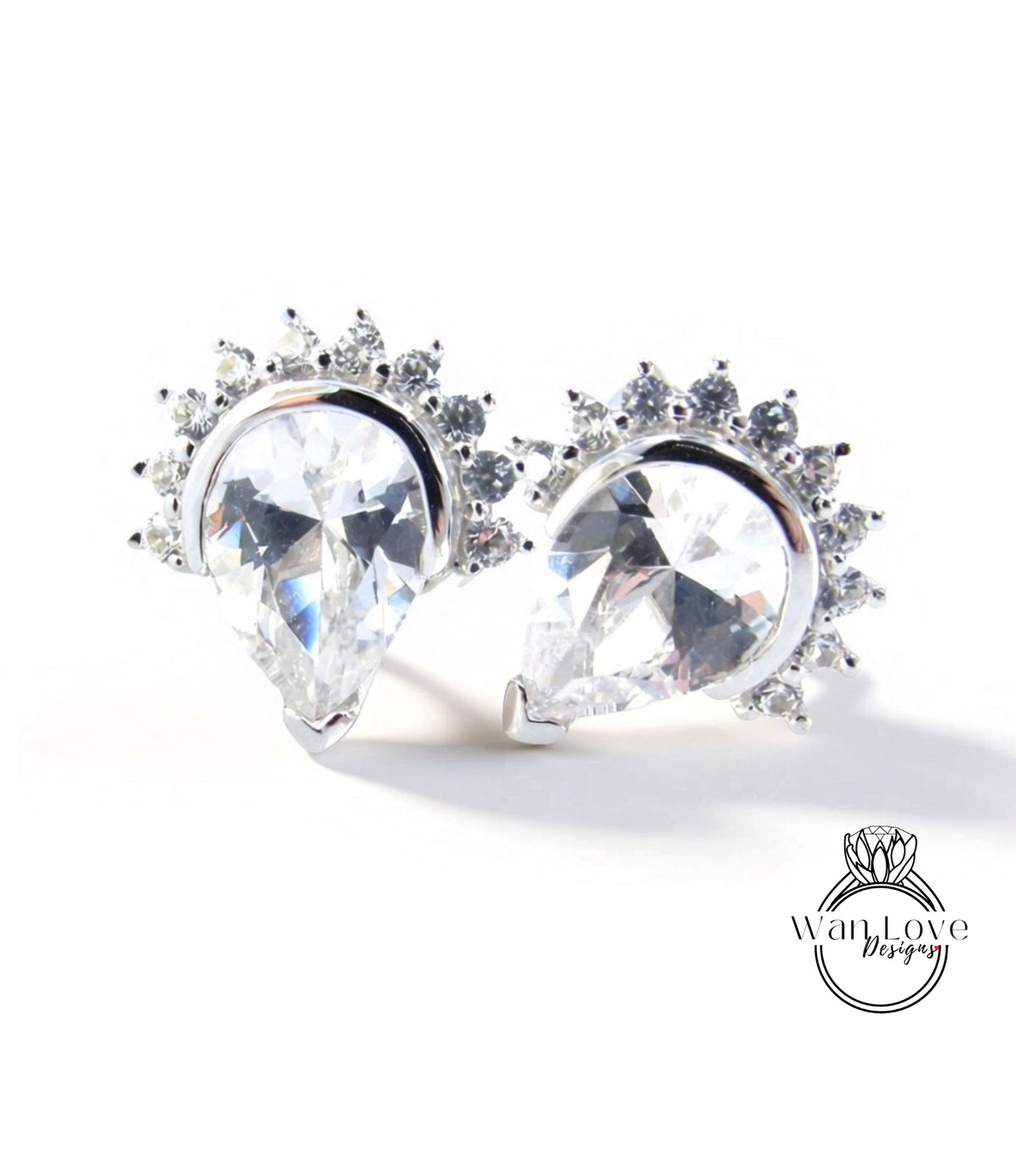 A pair of elegant earrings with large, clear gemstones set in a decorative metal frame.