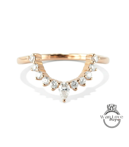 A gold ring with a large diamond in the center, surrounded by smaller diamonds, and a smaller diamond at the bottom.