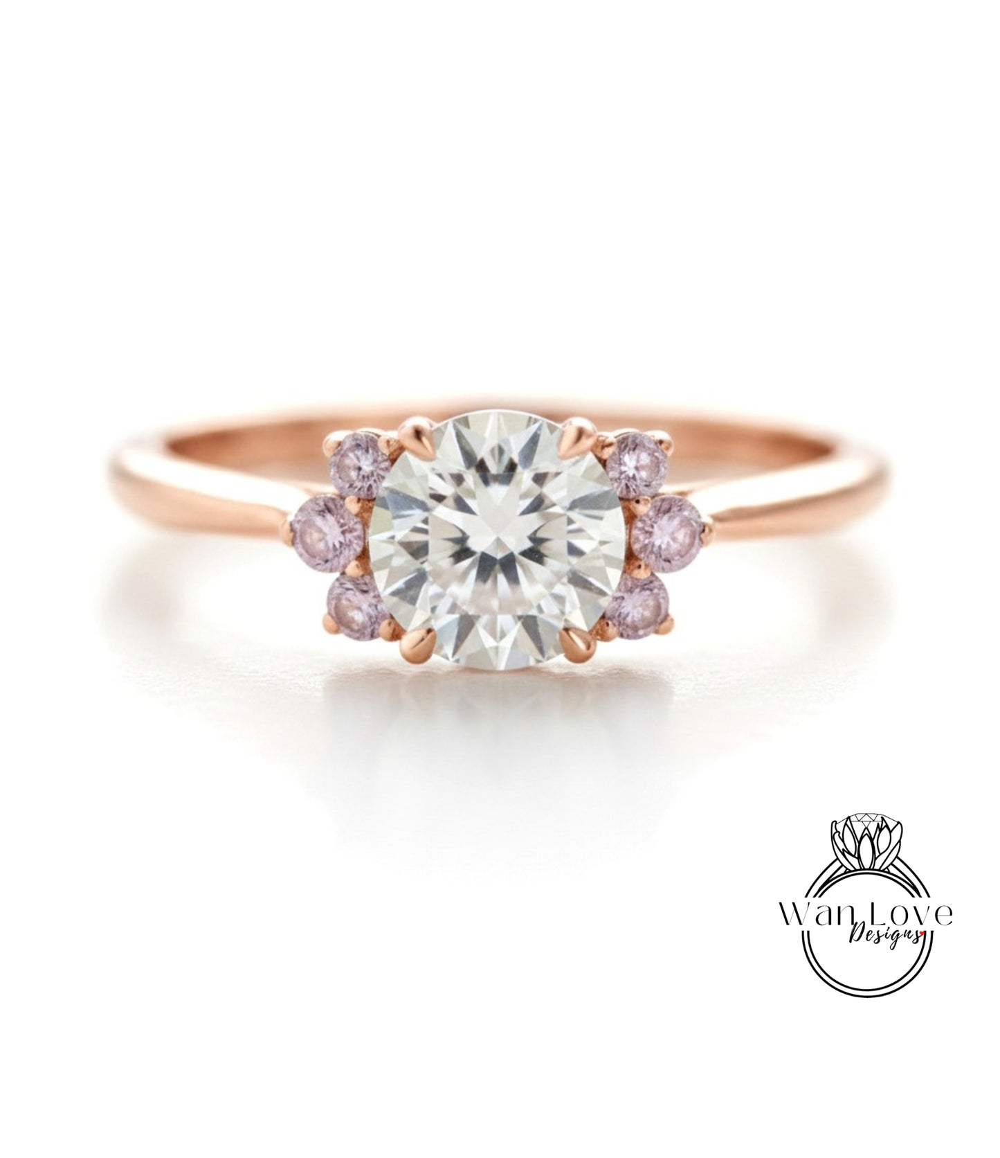 a beautiful engagement ring with a large central diamond surrounded by smaller diamonds on either side.