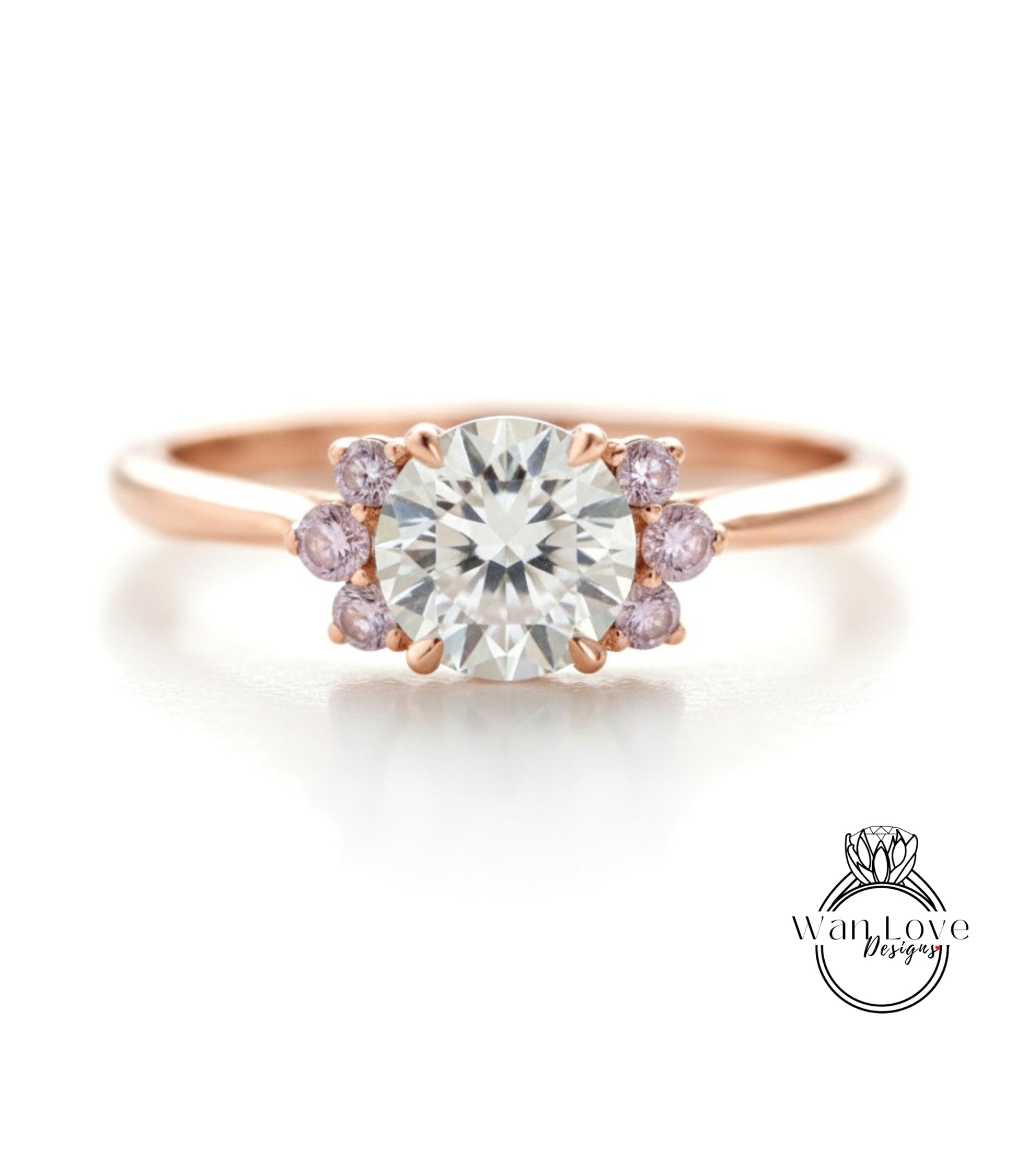 a beautiful engagement ring with a large central diamond surrounded by smaller diamonds on either side.