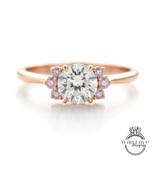 a beautiful engagement ring with a large central diamond surrounded by smaller diamonds on either side.