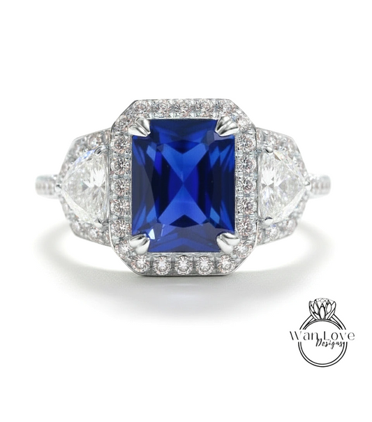 A stunning engagement ring with a large blue gemstone surrounded by smaller diamonds, set in a halo of smaller diamonds.