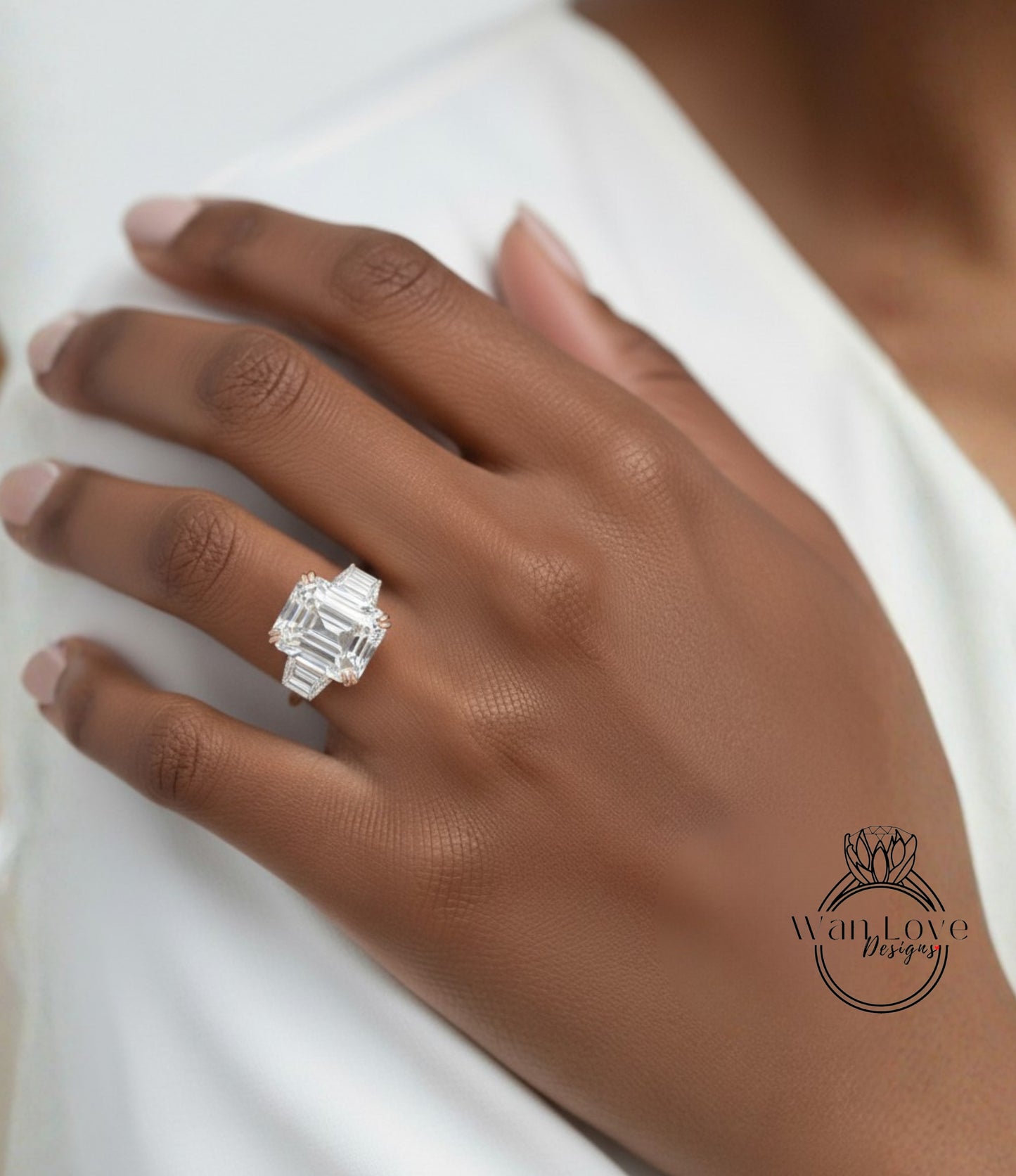 A close-up of a person's hand wearing a large diamond engagement ring.