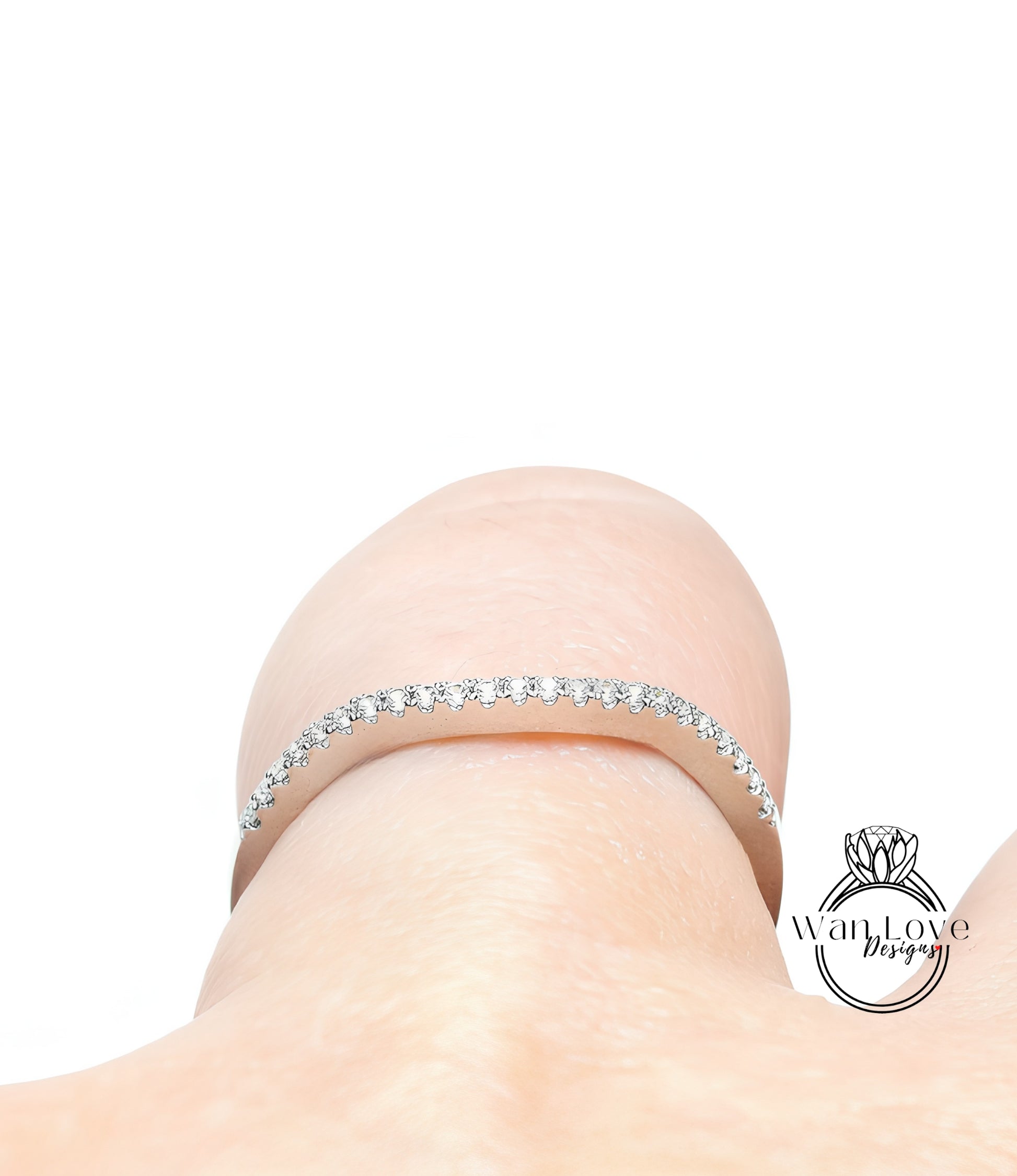 A close-up view of a delicate gold bracelet adorned with small diamonds, resting on a person's wrist.