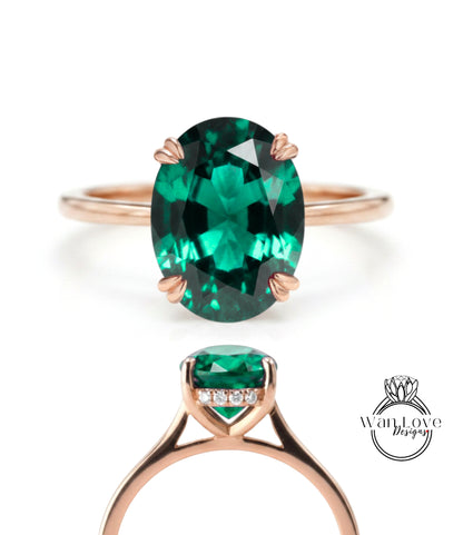 a rose gold ring with a large oval-shaped green gemstone set in the center.