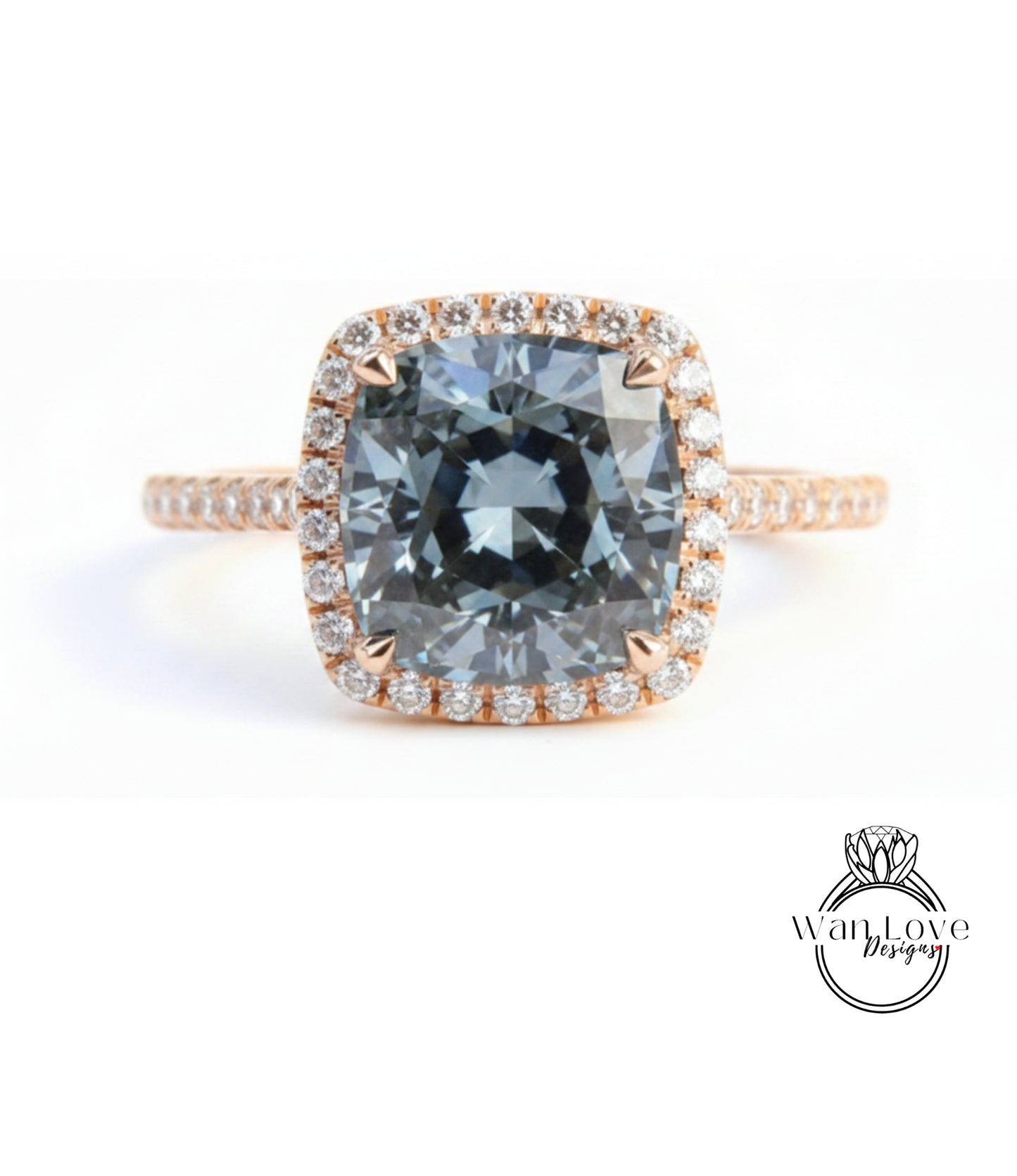 A large, blue gemstone engagement ring with a halo of smaller diamonds around the center stone.