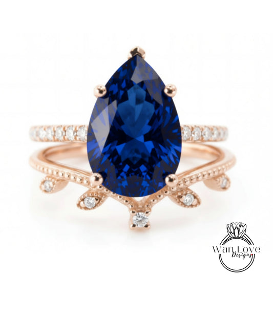 A close-up image of a gold ring with a large blue gemstone, possibly a sapphire, set in a rose gold band.
