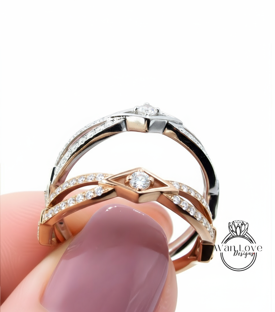 A close-up of a person's hand holding a ring with a diamond-encrusted band and a pinkish-pinkish background.