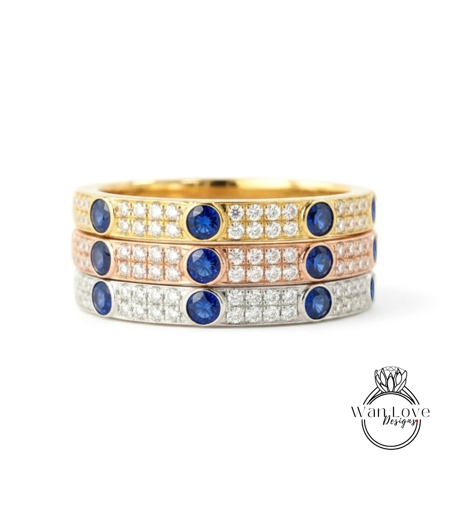 A stack of three rings with blue gemstones and diamonds set in gold and silver.