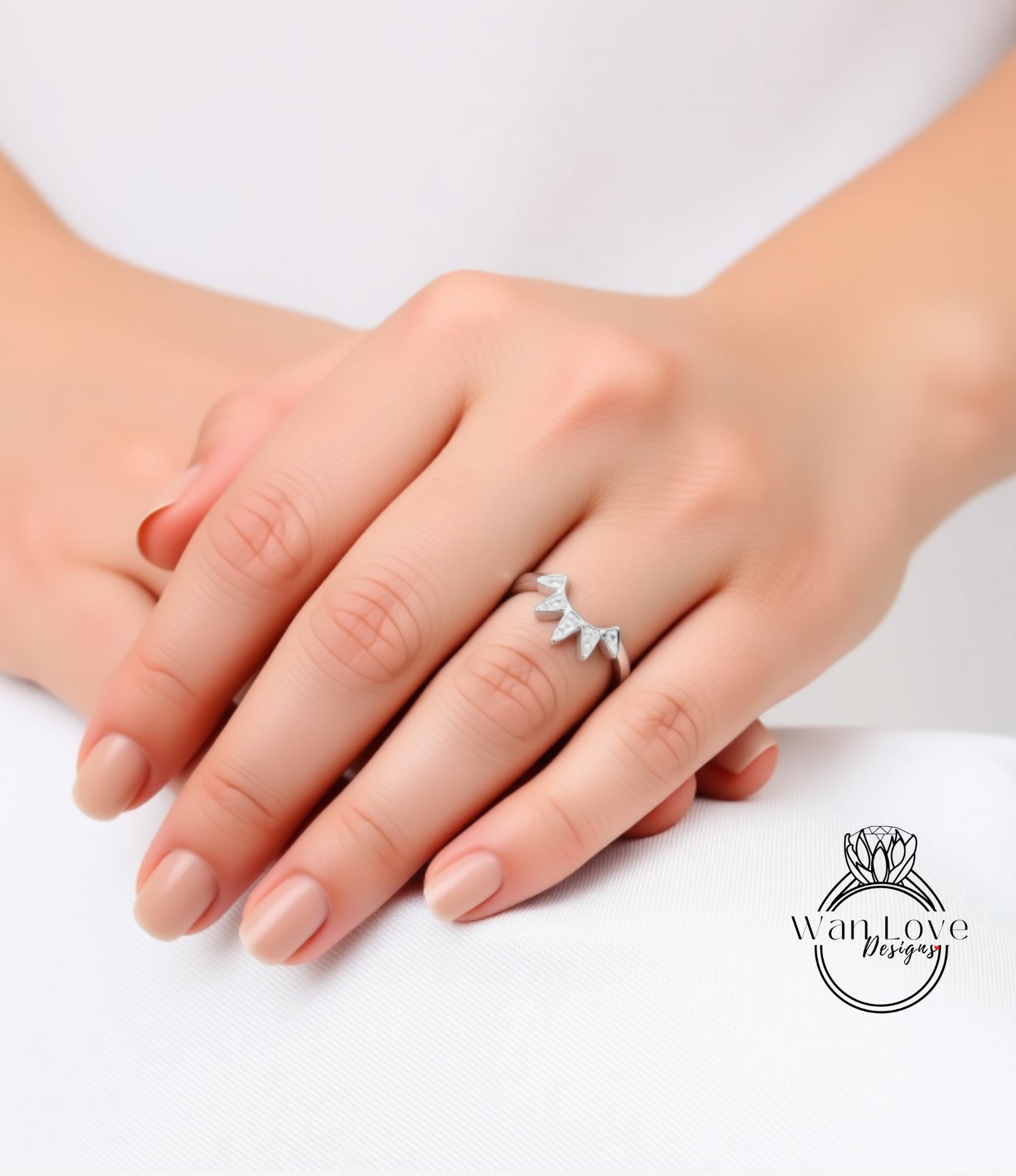 A close-up image of a person's hand wearing a ring with a unique design.