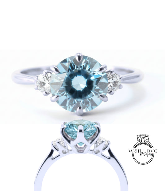 A close-up view of a silver ring with a large blue gemstone, showcasing the intricate design and craftsmanship of the piece.