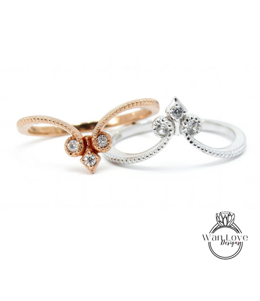 two rings with diamond accents, one in gold and the other in silver, showcasing their intricate designs and sparkling gemstones.