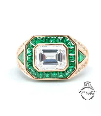 a ring with a large central gemstone surrounded by smaller green gemstones.