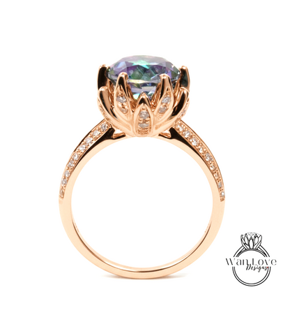 A gold ring with a large, colorful gemstone set in a decorative flower-like design.
