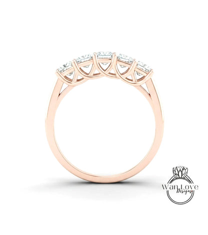 A gold ring with a row of diamonds set in the center.