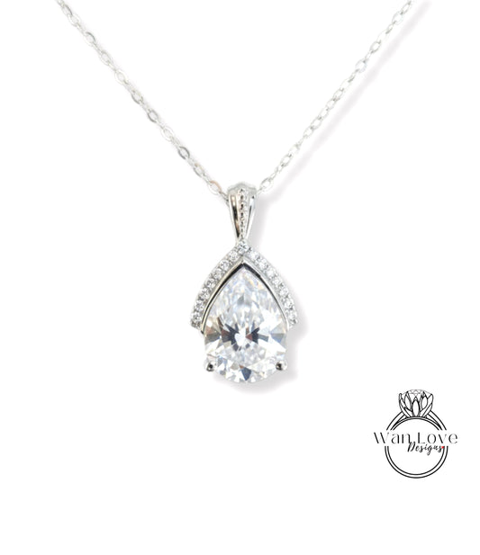 A silver necklace with a large, clear diamond pendant.