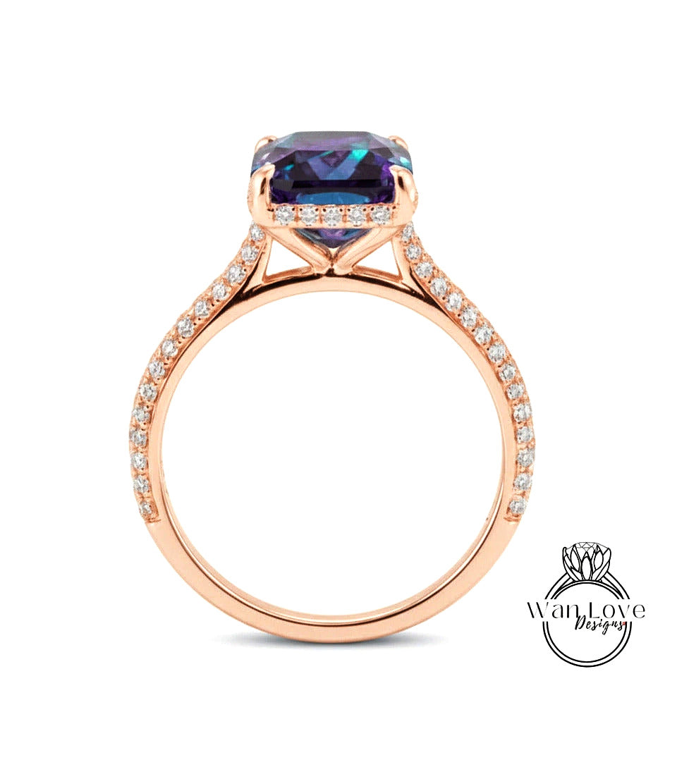 A rose gold engagement ring with a large purple gemstone set in the center, surrounded by smaller diamonds.