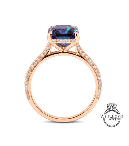 A rose gold engagement ring with a large purple gemstone set in the center, surrounded by smaller diamonds.