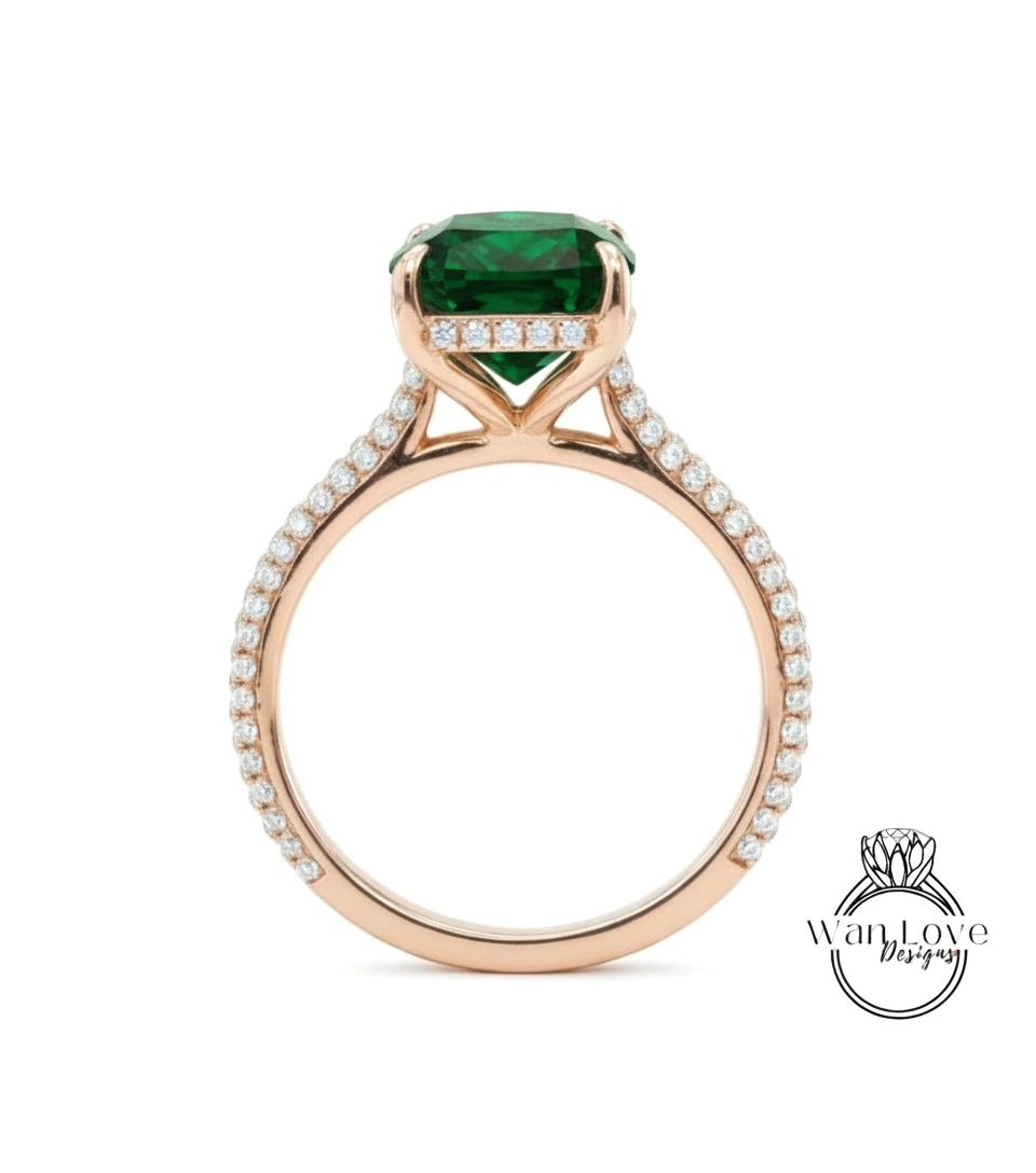 A gold ring with a large green gemstone set in the center, surrounded by smaller diamonds.