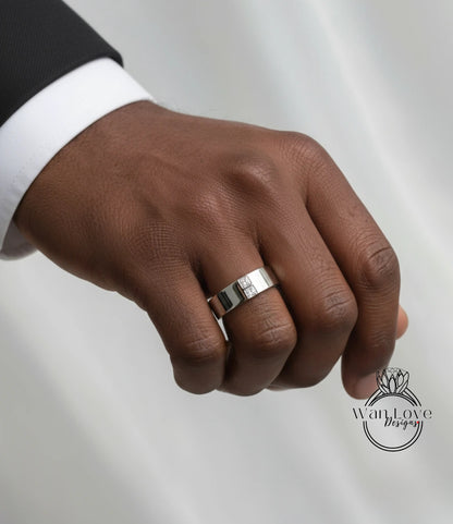 A close-up of a person's hand wearing a silver ring on the ring finger.