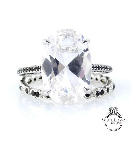 A large, clear gemstone ring with a black band around it, showcasing the intricate design and craftsmanship of the jewelry piece.