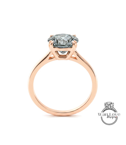 A rose gold engagement ring with a large, clear gemstone set in the center of the band.
