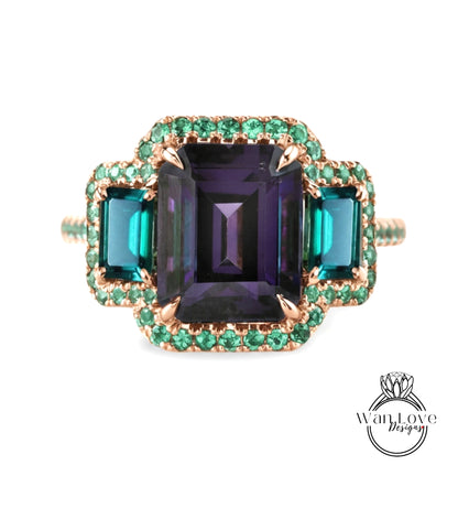 A ring with a large purple gemstone surrounded by smaller green gemstones, set in a gold band with a green accent.