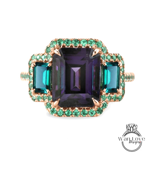 A ring with a large purple gemstone surrounded by smaller green gemstones, set in a gold band with a green accent.