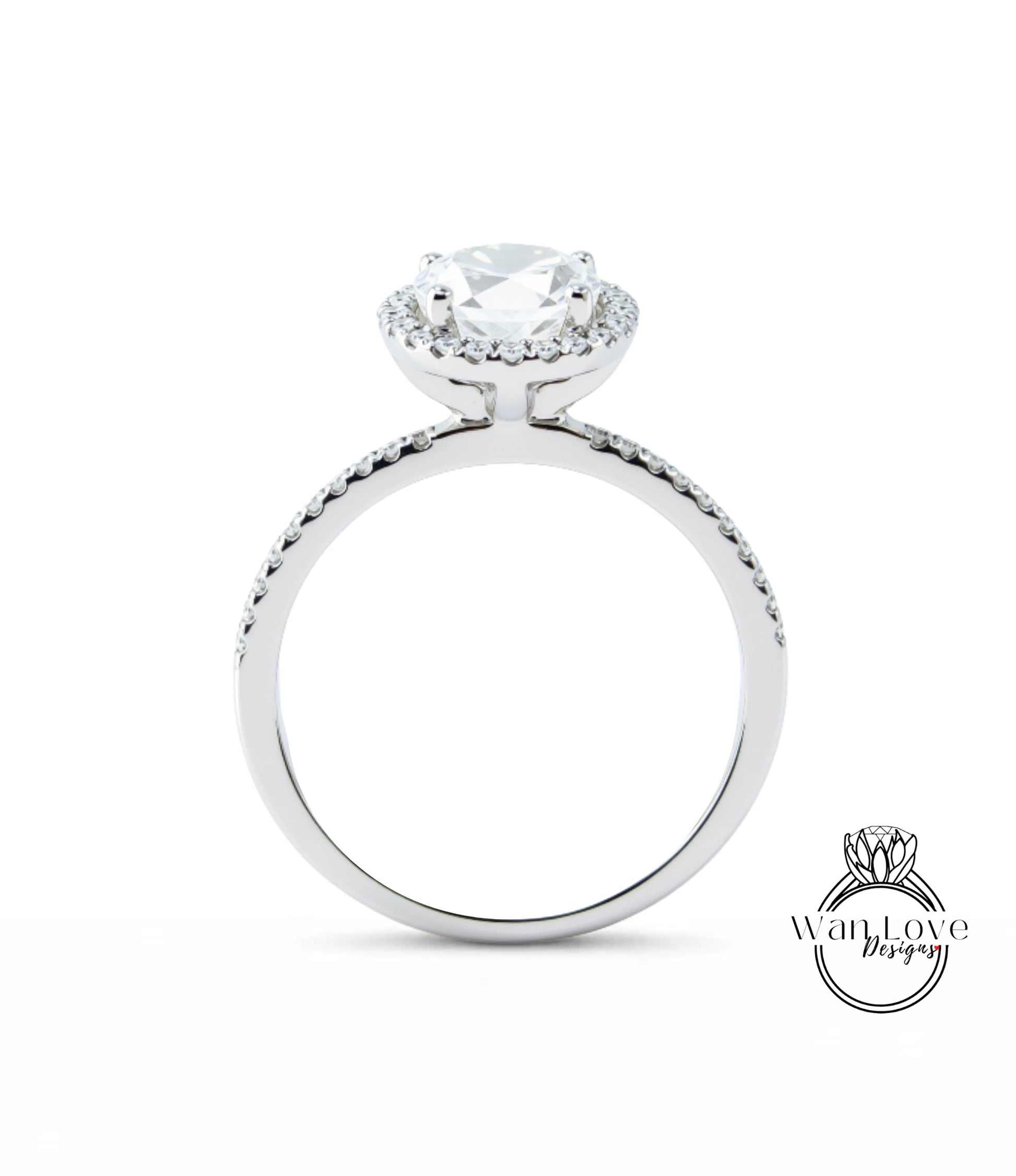 A silver engagement ring with a large central diamond surrounded by smaller diamonds, set in a halo of smaller diamonds.