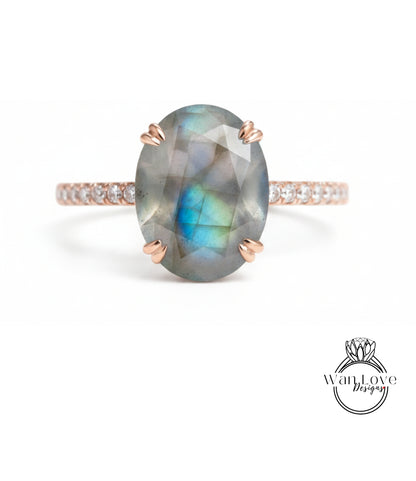 a ring with a large oval-shaped gemstone, possibly a diamond, set in a rose gold band.
