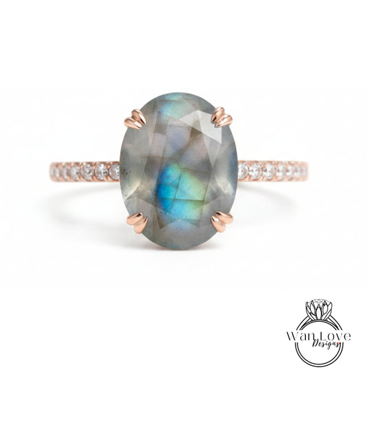 a ring with a large oval-shaped gemstone, possibly a diamond, set in a rose gold band.