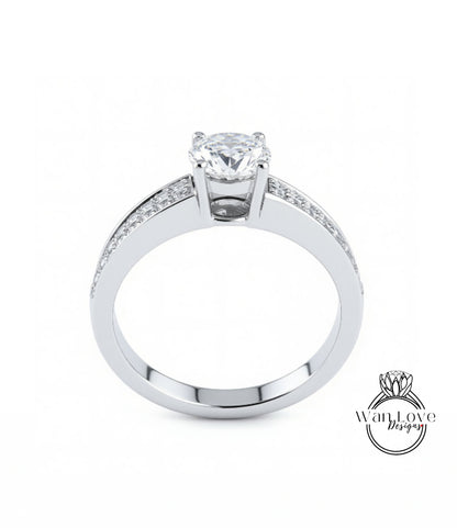 A silver engagement ring with a large central diamond and smaller diamonds along the band.