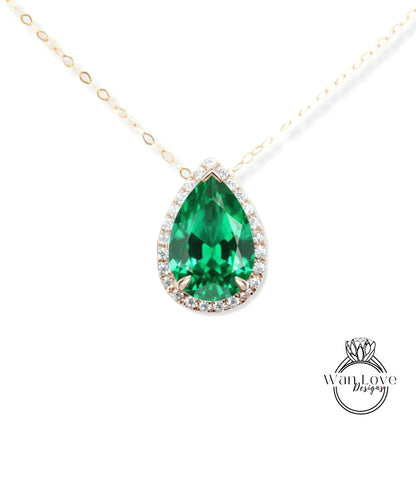 A close-up of a necklace with a large, green gemstone pendant.