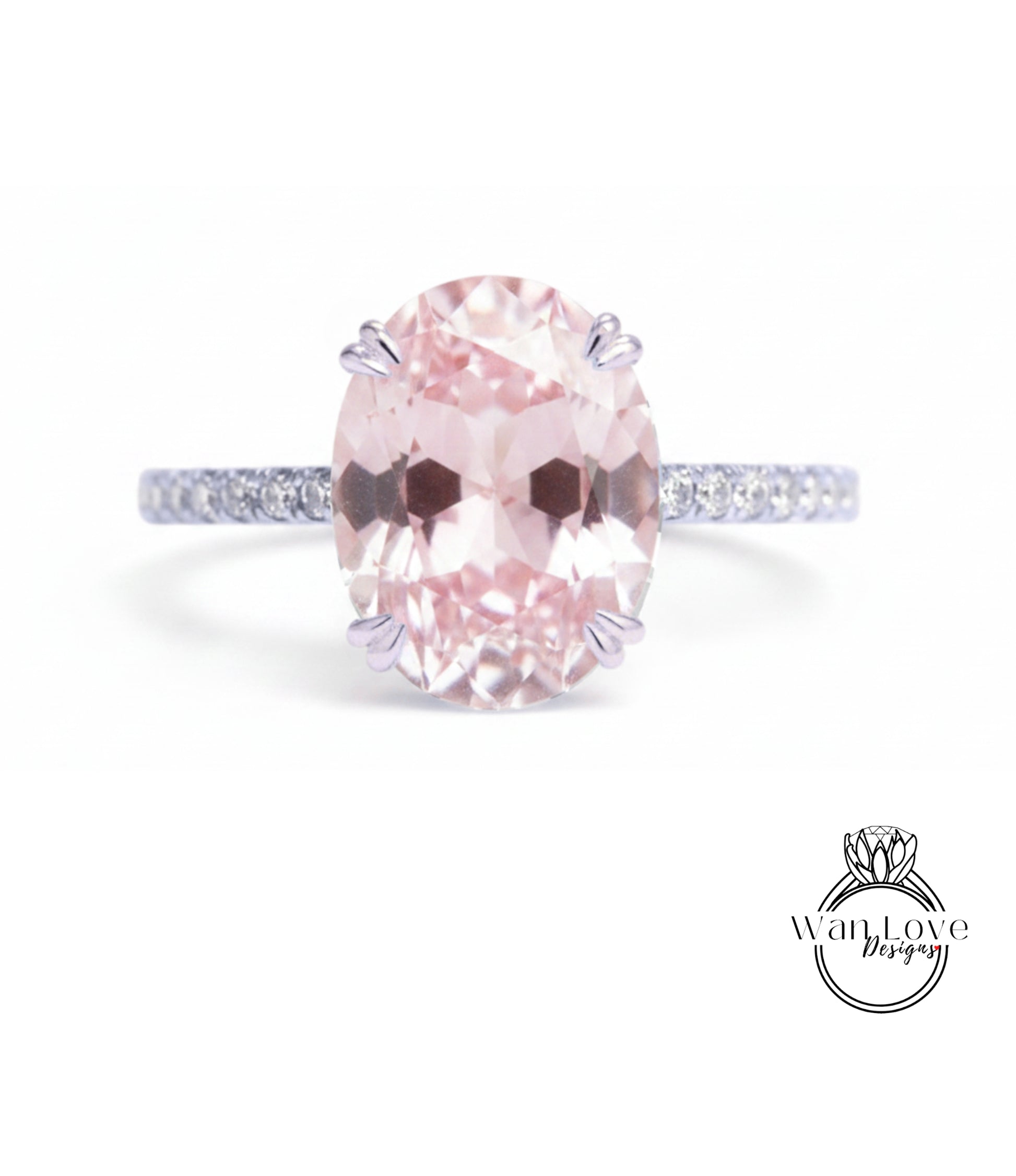 A pink gemstone engagement ring with a band and a logo for a jewelry designer.
