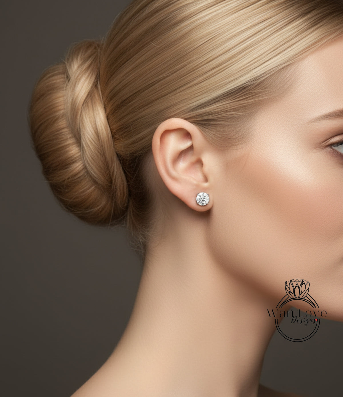 A close-up of a woman's face, focusing on her blonde hair and a diamond earring in her left ear.