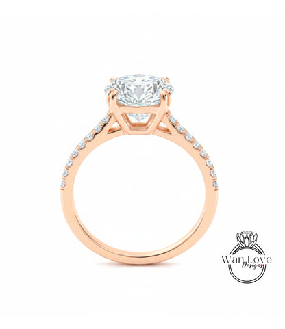 A close-up of a gold engagement ring with a large diamond set in the center, surrounded by smaller diamonds on the band.