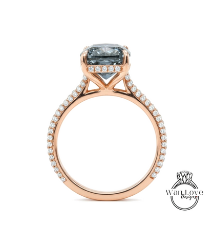 A rose gold engagement ring with a large blue gemstone set in the center, surrounded by smaller diamonds.