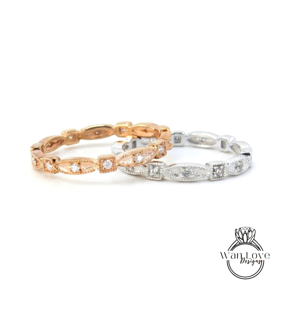 two rings, one in gold and one in silver, both adorned with small diamonds.