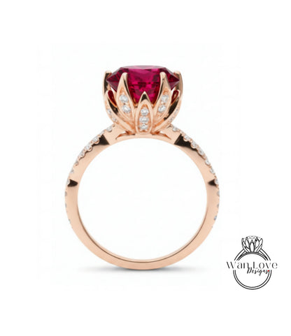 A rose gold ring with a large, deep red gemstone at the center, surrounded by small diamonds.