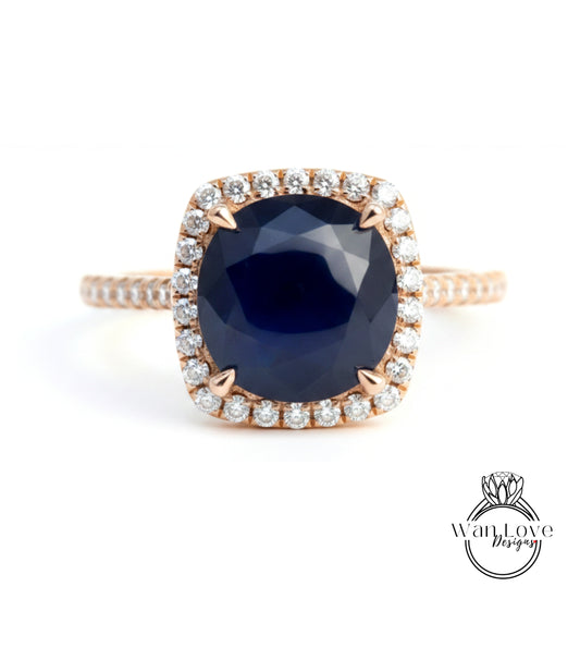 A gold ring with a large blue gemstone set in the center, surrounded by smaller diamonds.