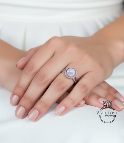 A close-up of a person's hand wearing a ring with a large, round gemstone.