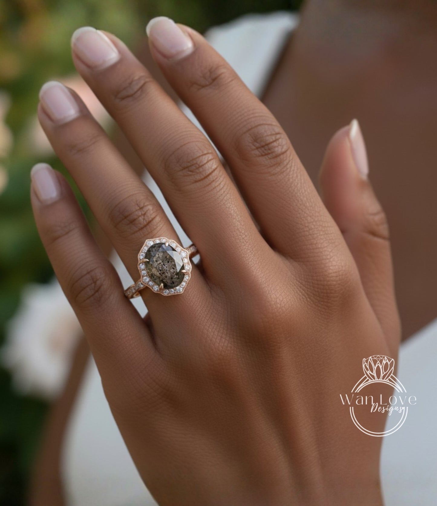 A close-up of a person's hand wearing a gold ring with a large oval-shaped stone set in the center.